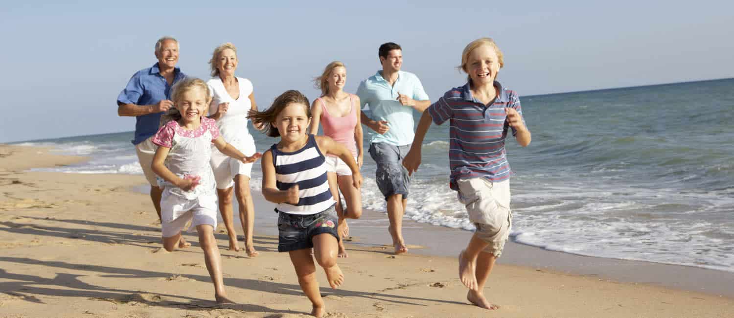 Family running on the beach